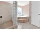 Bathroom features glass block shower and corner soaking tub with window at 114 Hardwood Ln, Canton, GA 30115