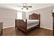 Bedroom featuring wood floors, a decorative ceiling fan, and a large window at 114 Hardwood Ln, Canton, GA 30115