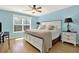 Inviting bedroom featuring a ceiling fan, warm natural light, and wood flooring at 114 Hardwood Ln, Canton, GA 30115