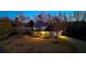 Two-story home with inviting covered porch, stone detail, and mature trees on expansive, well-maintained grounds at 114 Hardwood Ln, Canton, GA 30115