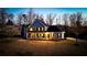 Beautiful two-story home with a covered front porch, stone accents, and mature trees on a large lot at 114 Hardwood Ln, Canton, GA 30115