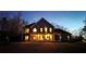 Night view of a two-story home with large front porch with chairs and bench at 114 Hardwood Ln, Canton, GA 30115