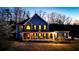 A beautiful two-story home with a full front porch and lush green lawn at 114 Hardwood Ln, Canton, GA 30115