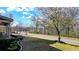 Well-manicured front yard with flower beds, mature trees, and a paved street at 114 Hardwood Ln, Canton, GA 30115