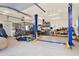 A spacious garage with a vehicle lift and ample storage space at 114 Hardwood Ln, Canton, GA 30115