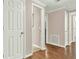 Hallway with wood flooring and access to multiple rooms at 114 Hardwood Ln, Canton, GA 30115