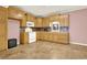 Functional kitchen with wooden cabinets, white appliances, and stylish backsplash at 114 Hardwood Ln, Canton, GA 30115