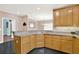 Bright kitchen features light wood cabinetry, granite countertops, and sleek black tile flooring at 114 Hardwood Ln, Canton, GA 30115