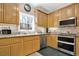 Kitchen with granite countertops, stainless steel appliances and natural wood cabinets at 114 Hardwood Ln, Canton, GA 30115