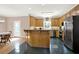Eat-in kitchen with a breakfast bar, stainless steel appliances and tiled floor at 114 Hardwood Ln, Canton, GA 30115
