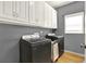 Modern laundry room with updated appliances and storage cabinets at 114 Hardwood Ln, Canton, GA 30115