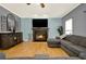 Living room with fireplace, large screen television and hardwood floors at 114 Hardwood Ln, Canton, GA 30115