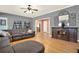 Living room featuring a large sectional sofa, hardwood floors and adjoined rooms at 114 Hardwood Ln, Canton, GA 30115