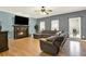 Comfortable living room with a fireplace, ceiling fan and hardwood floors at 114 Hardwood Ln, Canton, GA 30115