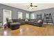 Spacious living room with a large sectional sofa and hardwood floors at 114 Hardwood Ln, Canton, GA 30115