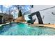 A backyard swimming pool features a water slide, creating a fun and inviting space for recreation at 114 Hardwood Ln, Canton, GA 30115