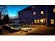 Swimming pool with brick surround, slide, outdoor umbrella, and lush landscaping in the backyard at night at 114 Hardwood Ln, Canton, GA 30115