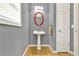 Compact powder room with pedestal sink, and oval mirror at 114 Hardwood Ln, Canton, GA 30115