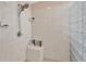 Shower with white tile surround and glass block accent wall at 114 Hardwood Ln, Canton, GA 30115