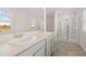 Bright bathroom with double sinks, a large mirror, and a glass-enclosed shower at 1622 Palladian Way, Lithonia, GA 30058