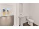 Powder room featuring a pedestal sink, toilet, and a window at 1622 Palladian Way, Lithonia, GA 30058