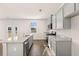 Open concept kitchen with granite countertops, stainless steel appliances, and gray cabinets at 1622 Palladian Way, Lithonia, GA 30058