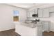 Bright kitchen with granite countertops, stainless steel appliances, island, and hardwood floors at 1622 Palladian Way, Lithonia, GA 30058