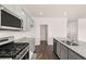 Modern kitchen featuring stainless steel appliances, gray cabinets, and granite countertops at 1622 Palladian Way, Lithonia, GA 30058