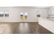 Spacious living room featuring hardwood floors and natural light from a double glass door at 1622 Palladian Way, Lithonia, GA 30058