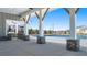 Poolside pavilion showcasing stone pillars, exposed rafters, ceiling fans, and outdoor grill overlooking community pool at 1622 Palladian Way, Lithonia, GA 30058