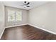 Bedroom features ceiling fan, hardwood floors and large window providing ample natural light at 3263 Dodson Dr, Atlanta, GA 30344