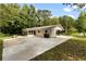 Exterior view of home with long driveway, mature trees, and white painted brick at 3263 Dodson Dr, Atlanta, GA 30344