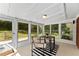 Bright sunroom featuring multiple windows offering backyard views, neutral decor, and an exterior access door at 3263 Dodson Dr, Atlanta, GA 30344