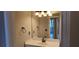 Bathroom with a modern vanity, a large mirror, and a stylish lighting fixture at 5763 Dexters Mill Pl, Buford, GA 30518