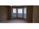 Bedroom with bay window and carpeted floors at 5763 Dexters Mill Pl, Buford, GA 30518