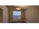 Cozy dining area featuring hardwood floors, a chandelier, and a large window at 5763 Dexters Mill Pl, Buford, GA 30518