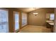 Bright dining area features neutral walls, a door to the exterior and modern lighting at 5763 Dexters Mill Pl, Buford, GA 30518