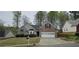 Charming brick and gray siding home with an attached two-car garage, complemented by mature landscaping at 5763 Dexters Mill Pl, Buford, GA 30518