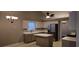 Well-lit kitchen featuring an island, stainless steel appliances, neutral cabinets and countertops at 5763 Dexters Mill Pl, Buford, GA 30518