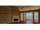 Cozy living room featuring wood floors, a fireplace and built-in shelves at 5763 Dexters Mill Pl, Buford, GA 30518