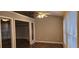 Open living room with a ceiling fan, and adjacent room with a fireplace and built-in shelves at 5763 Dexters Mill Pl, Buford, GA 30518
