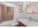 Bathroom with pink tiled walls, a bathtub with shower, and a stylish vanity with a modern sink at 1078 Piedmont Ne Ave # 203, Atlanta, GA 30309