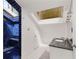 Bathroom showcasing blue tiled shower, skylight and vanity with dark granite countertop at 1078 Piedmont Ne Ave # 203, Atlanta, GA 30309