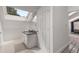 White bathroom with a skylight, gray granite countertop and white cabinets at 1078 Piedmont Ne Ave # 203, Atlanta, GA 30309