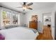 Bedroom with hardwood floors, neutral decor, double windows offering natural light, and view to kitchen at 1078 Piedmont Ne Ave # 203, Atlanta, GA 30309