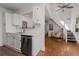 Bright kitchen with white cabinets, stainless steel dishwasher, open floor plan, and hardwood floors at 1078 Piedmont Ne Ave # 203, Atlanta, GA 30309