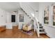 Cozy living room with staircase, wood floors, natural light, and stylish accents at 1078 Piedmont Ne Ave # 203, Atlanta, GA 30309