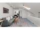 Bright living room with skylight, gray sofa, accent rug, and modern decor at 1078 Piedmont Ne Ave # 203, Atlanta, GA 30309