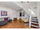 Inviting living room featuring hardwood floors, a staircase, and stylish decor at 1078 Piedmont Ne Ave # 203, Atlanta, GA 30309