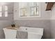Bright bathroom features a soaking tub with tile surround, a window, and chrome fixtures at 125 Whitman Grv, Fayetteville, GA 30215